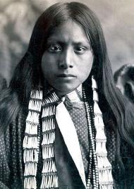 Apache wearing a bone necklace, 1920